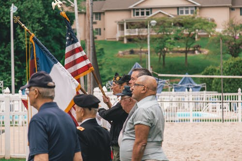 Vets holding flags up